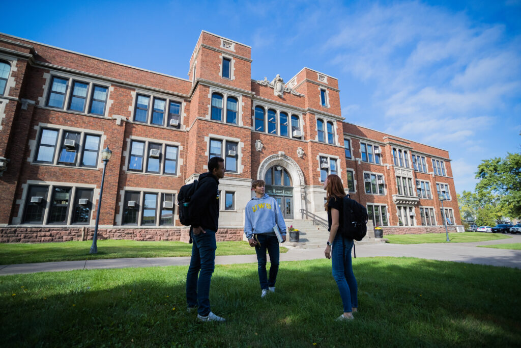 Students standing in front of building