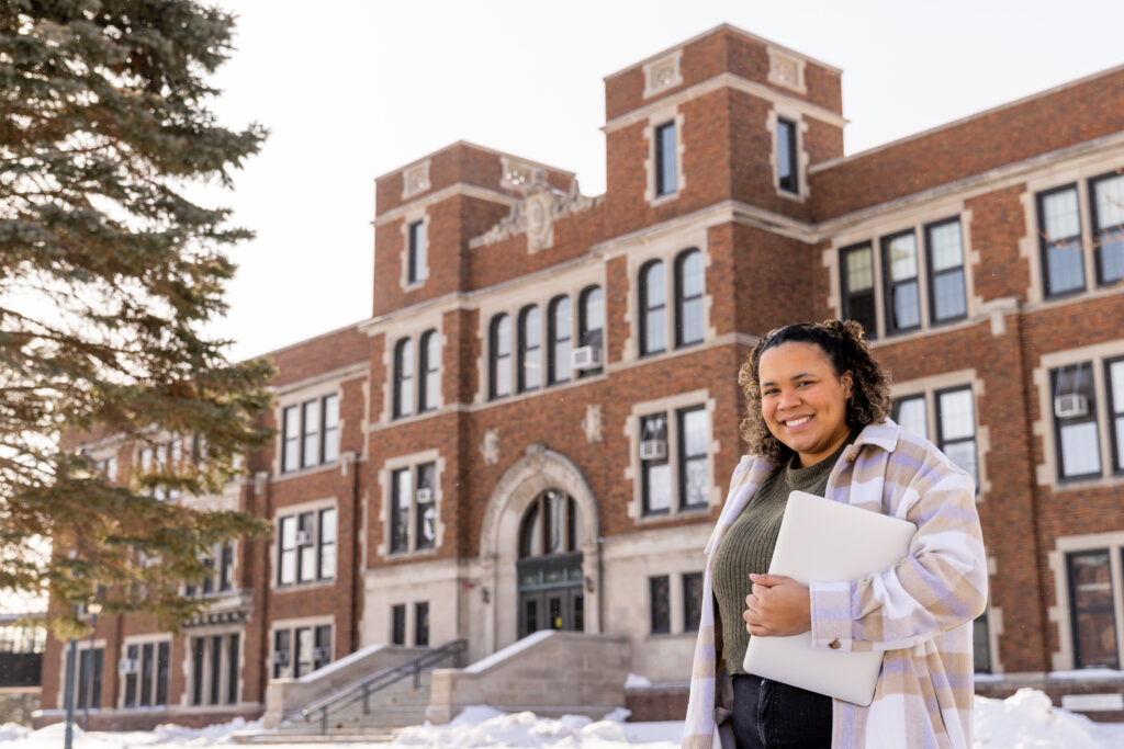 Lindsey standing in front of campus building