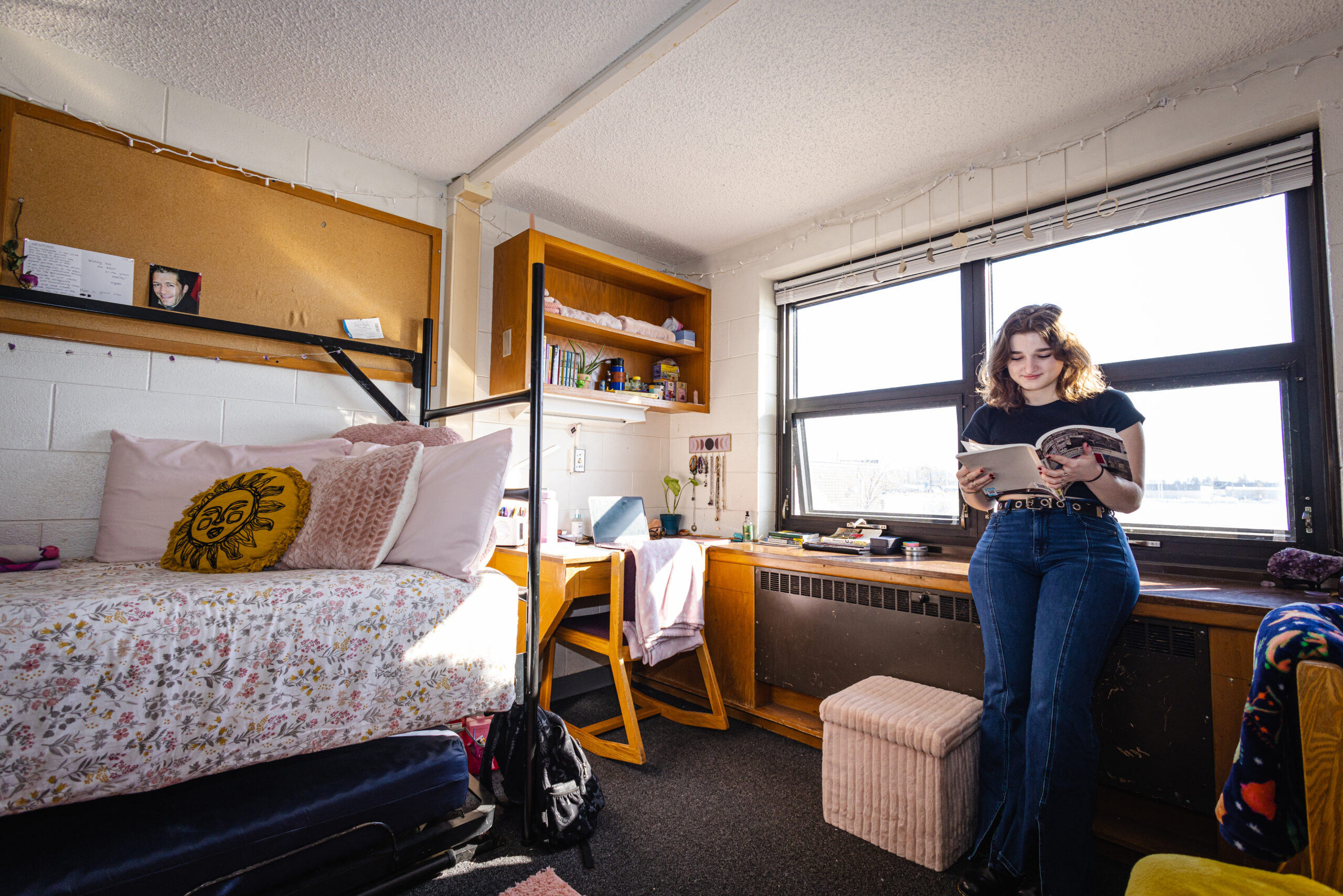 Student reading book in dorm room
