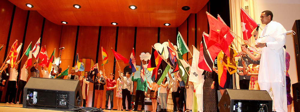Students holding flags from all over the world.