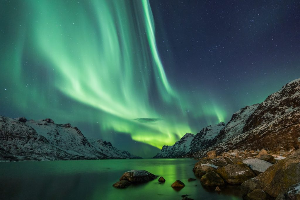 Northern lights above waters and mountains