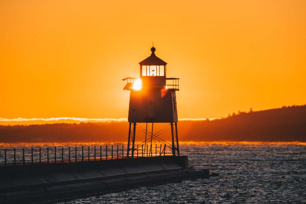 Lighthouse sunset on pier