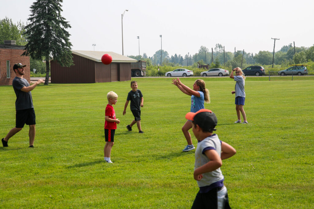 Picture of little yellowjackets playing with a ball outside during a youth camp