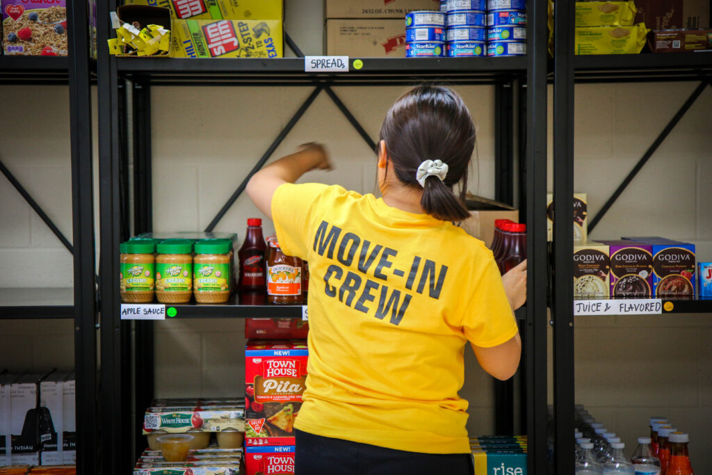 Move-in Crew Student stocking food pantry
