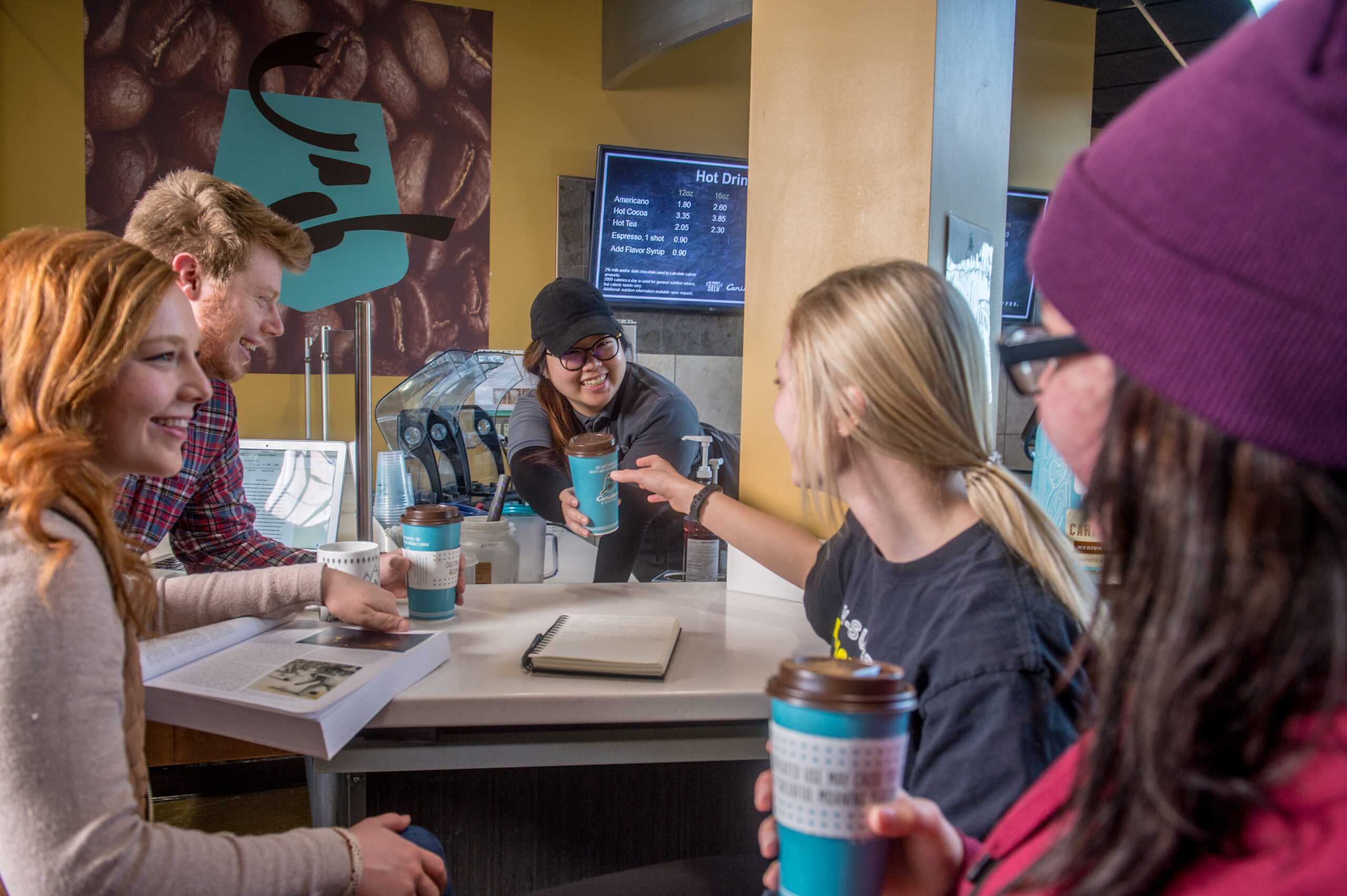 Student serving coffee on campus