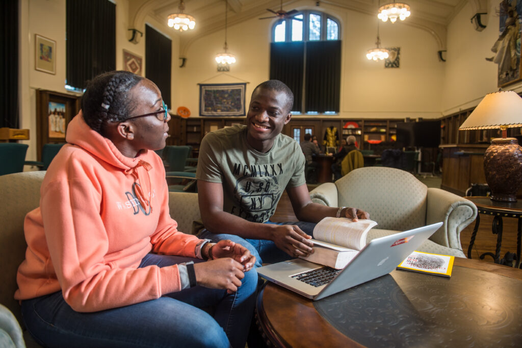 Tutor and student reviewing book