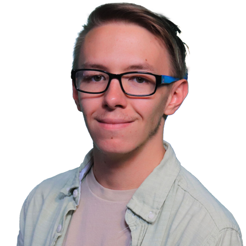 A young person with light skin, short brown hair, and glasses is wearing a light-colored shirt over a beige t-shirt, standing against a plain white background and smiling slightly, reflecting confidence in achieving superior outcomes.