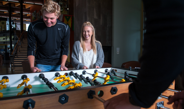 Two students playing table soccer
