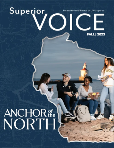 Cover of Superior Voice Fall 2023 shows four students, future alumni, sitting on a lakeshore with a lighthouse in the background, all framed inside a Wisconsin state outline with the text Anchor of the North.