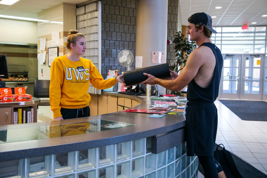 UW-Superior student employee working at the front desk of the Marcovich Wellness Center