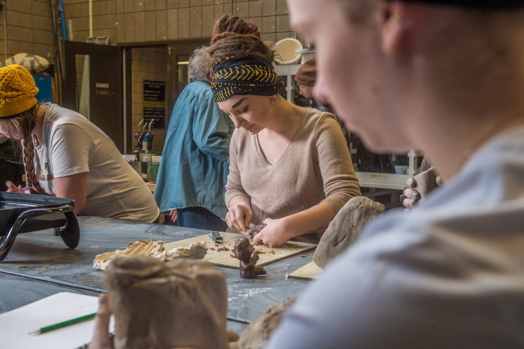 UW-Superior students sculpting with clay