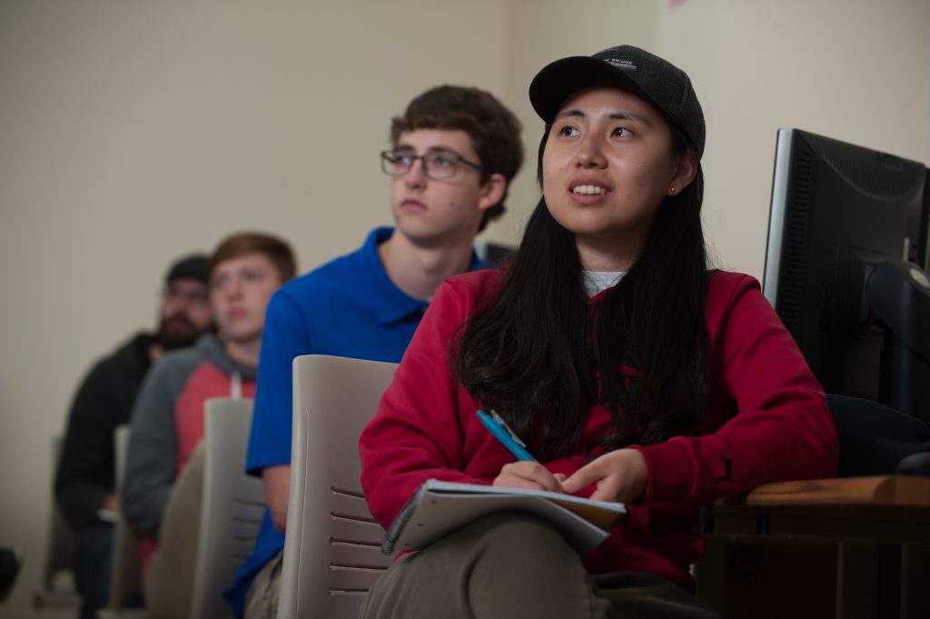 Students sitting in a lecture room listening