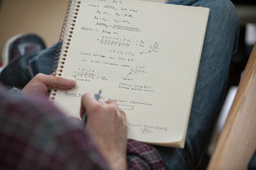 Student taking math notes